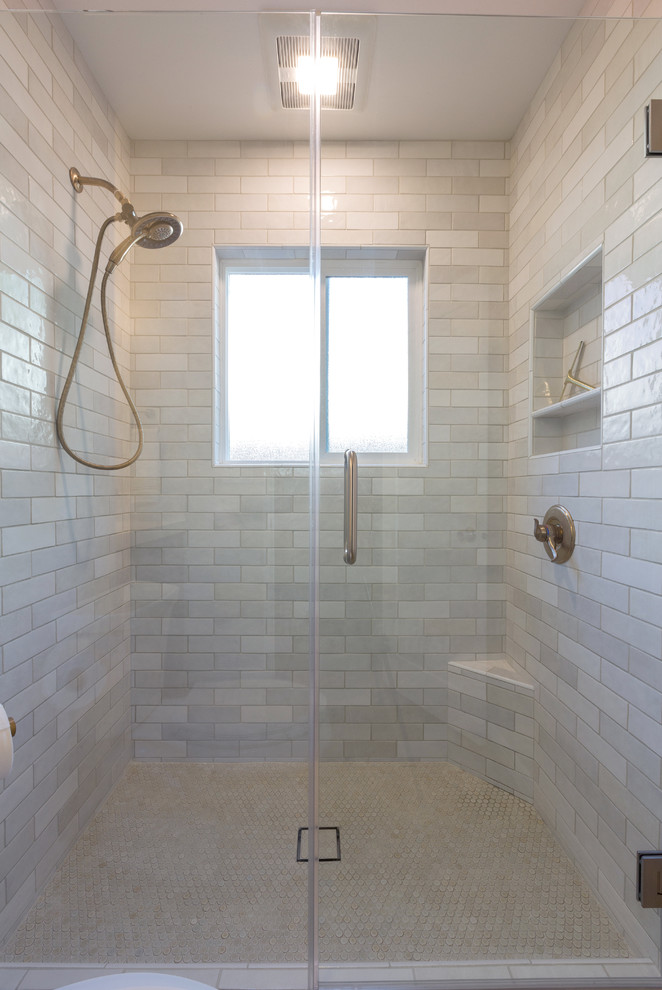 This is an example of a modern family bathroom in Sacramento with blue cabinets, a corner shower, a one-piece toilet, white tiles, white walls, a submerged sink, quartz worktops, brown floors, a hinged door and white worktops.