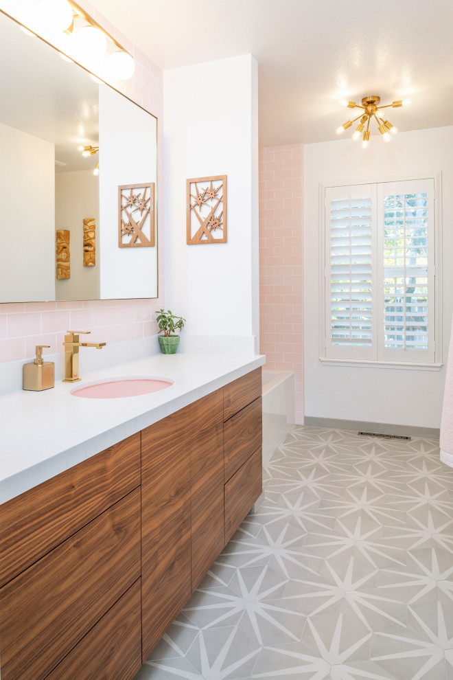 Traditional bathroom in Sacramento with medium wood cabinets, a corner bath, a corner shower, pink tiles, ceramic tiles, white walls, porcelain flooring, a submerged sink, quartz worktops, multi-coloured floors and white worktops.