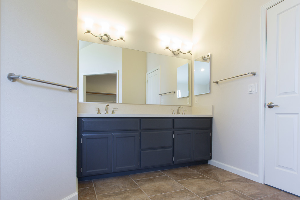 Example of a large master brown tile porcelain tile bathroom design in Sacramento with a drop-in sink, black cabinets and quartz countertops