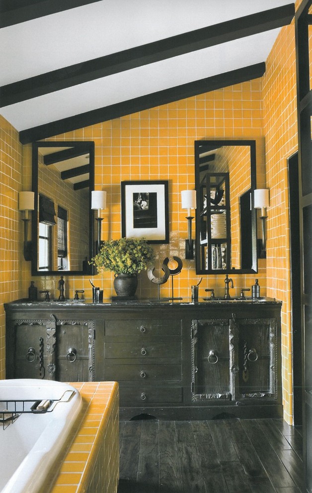 This is an example of a medium sized rustic bathroom in Los Angeles with recessed-panel cabinets, black cabinets, a built-in bath, yellow tiles, ceramic tiles, yellow walls, a submerged sink and granite worktops.