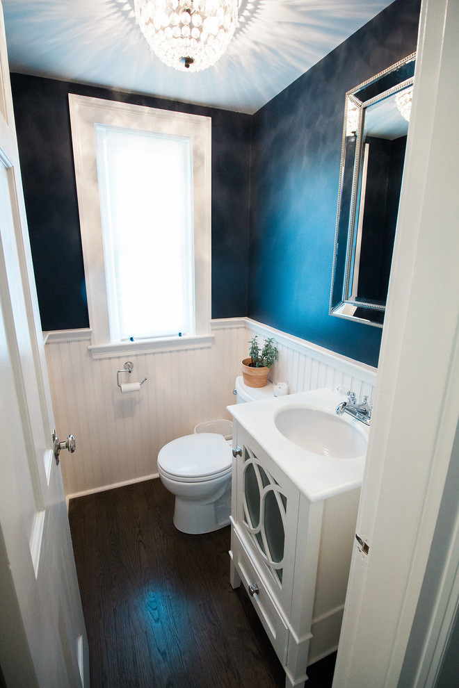 Design ideas for a medium sized classic shower room bathroom in Boston with glass-front cabinets, white cabinets, a two-piece toilet, blue walls, dark hardwood flooring, a submerged sink and solid surface worktops.