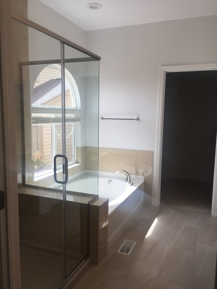 Medium sized classic ensuite bathroom in Denver with recessed-panel cabinets, dark wood cabinets, an alcove bath, a corner shower, beige tiles, porcelain tiles, white walls, porcelain flooring, an integrated sink, solid surface worktops, beige floors and a hinged door.