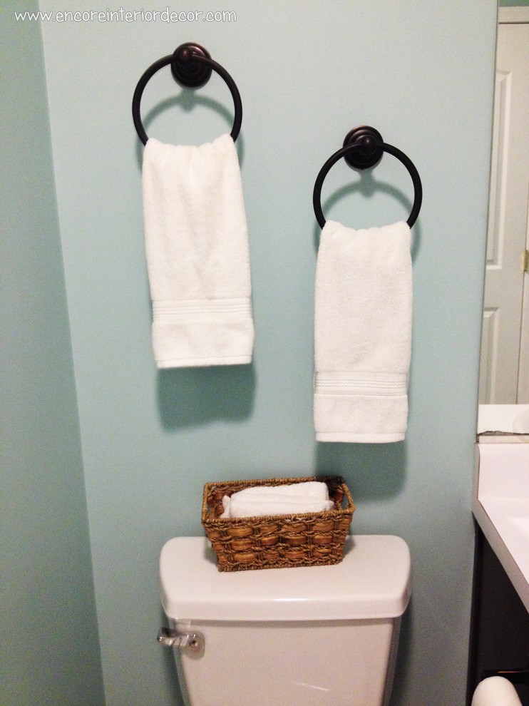 This is an example of a small family bathroom in Other with raised-panel cabinets, brown cabinets, laminate worktops, blue walls and lino flooring.