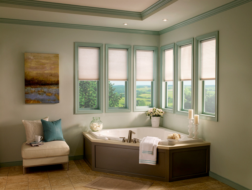 На фото: большая главная ванная комната в современном стиле с угловой ванной, коричневой плиткой, зелеными стенами, накладной раковиной, плоскими фасадами и зелеными фасадами