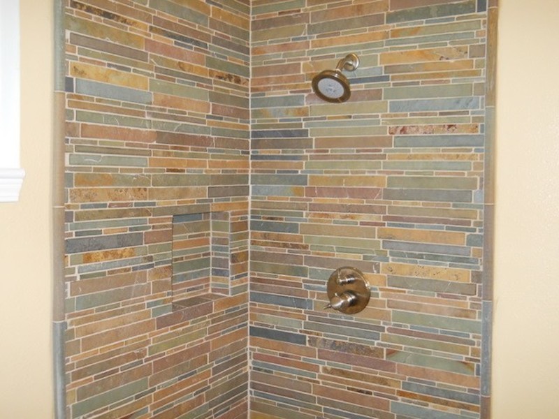 Corner shower - multicolored tile corner shower idea in San Francisco with beige walls
