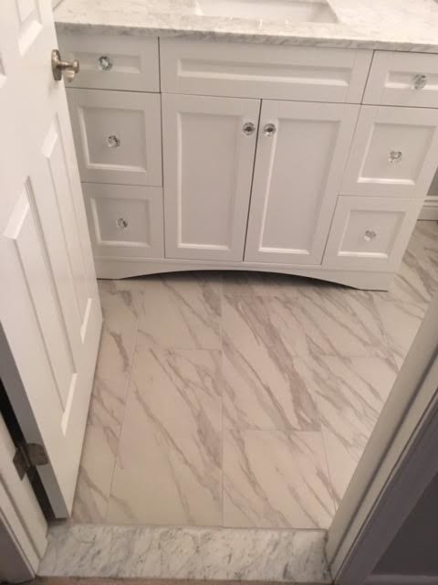 This is an example of a medium sized classic ensuite bathroom in Baltimore with freestanding cabinets, white cabinets, white walls, a submerged sink, marble worktops, a corner bath, a walk-in shower, a one-piece toilet, grey tiles, white tiles, marble tiles and marble flooring.