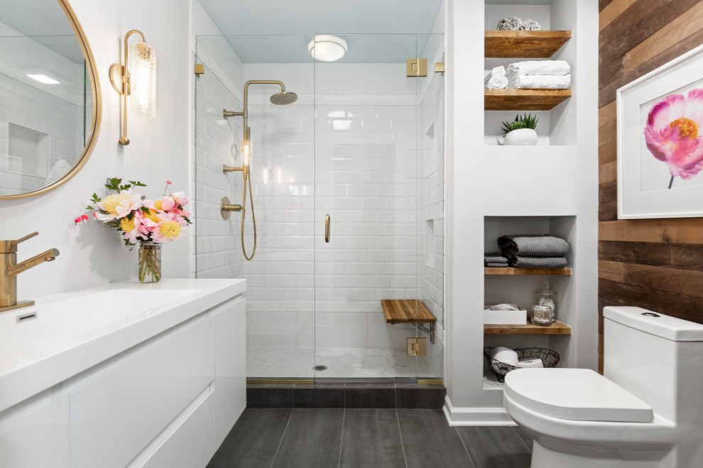 This is an example of a contemporary shower room bathroom in Bridgeport with flat-panel cabinets, white cabinets, an alcove shower, a one-piece toilet, brown tiles, white walls, an integrated sink, grey floors, a hinged door, white worktops, a wall niche, a shower bench, a single sink and a floating vanity unit.