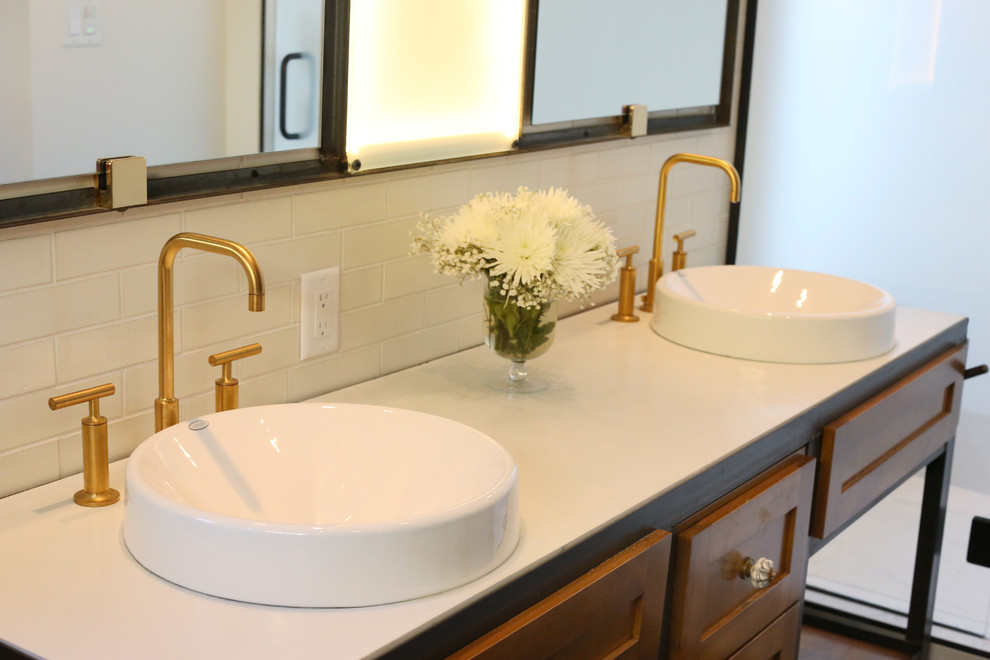 Photo of a large urban ensuite bathroom in Minneapolis with a built-in sink, recessed-panel cabinets, medium wood cabinets, concrete worktops, a freestanding bath, an alcove shower, a one-piece toilet, white tiles, porcelain tiles, white walls, cork flooring and brown floors.