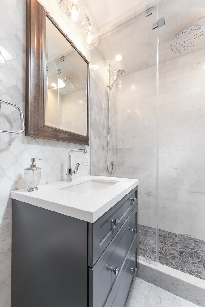 This is an example of a small contemporary shower room bathroom in San Francisco with shaker cabinets, grey cabinets, an alcove shower, a wall mounted toilet, grey tiles, marble tiles, white walls, marble flooring, a submerged sink, quartz worktops, grey floors and a hinged door.