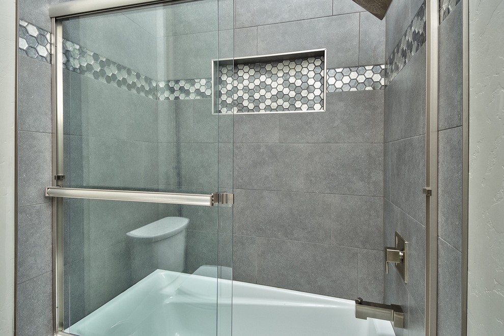 Design ideas for a medium sized classic shower room bathroom in Denver with shaker cabinets, grey cabinets, an alcove bath, a shower/bath combination, grey tiles, multi-coloured tiles, porcelain tiles, white walls, a vessel sink, granite worktops and a sliding door.