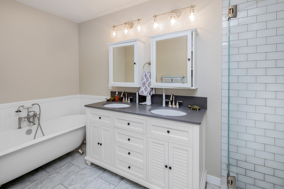 Inspiration for a large modern master white tile and subway tile marble floor and white floor bathroom remodel in Chicago with louvered cabinets, white cabinets, beige walls, an undermount sink, quartz countertops and a hinged shower door