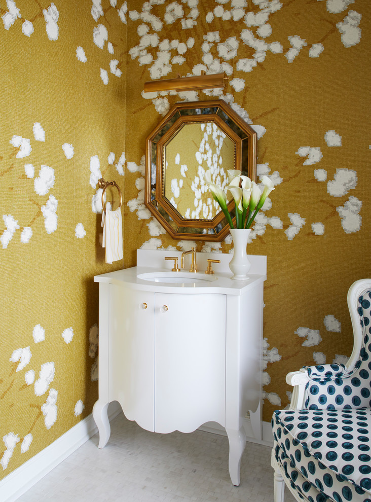 Ispirazione per una stanza da bagno tradizionale di medie dimensioni con ante bianche, pareti gialle, pavimento in marmo, lavabo sottopiano, top in marmo e pavimento bianco