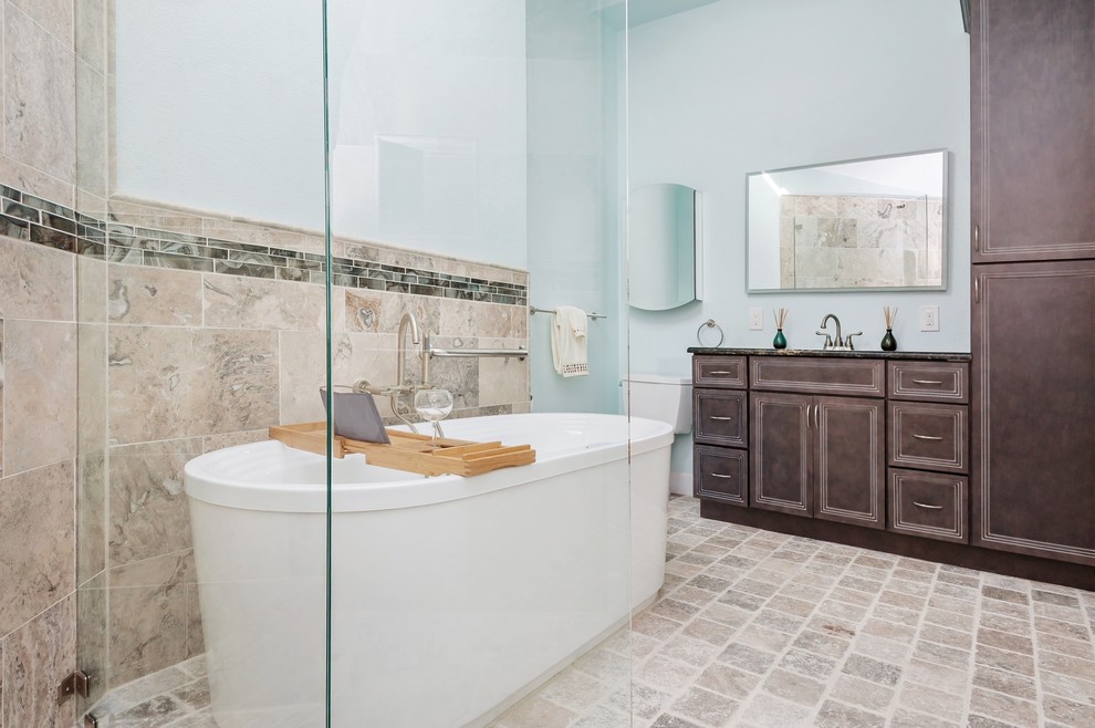 Inspiration for a mid-sized craftsman master brown tile and ceramic tile ceramic tile and beige floor bathroom remodel in Tampa with recessed-panel cabinets, dark wood cabinets, blue walls, an undermount sink and brown countertops