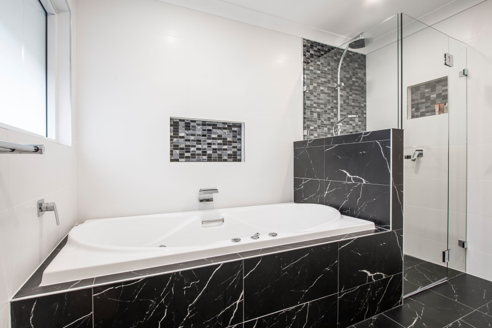 Large modern ensuite bathroom in Sydney with recessed-panel cabinets, white cabinets, a hot tub, a corner shower, a one-piece toilet, white tiles, ceramic tiles, white walls, cement flooring, a vessel sink, engineered stone worktops, black floors, a hinged door, yellow worktops, a wall niche, a single sink, a built in vanity unit and a coffered ceiling.