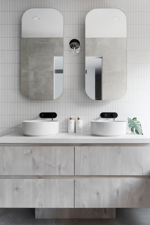 Timeless Gray: Bathroom Mirror Inspirations in a Gray Haven with White Vessel Sinks and Black Faucets