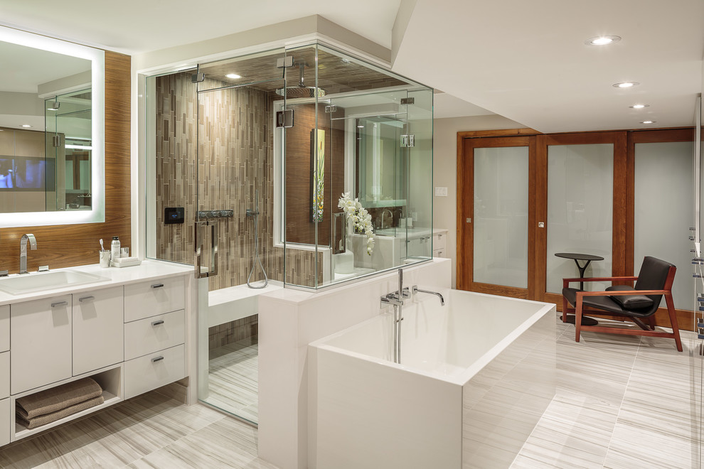 Design ideas for a medium sized contemporary ensuite bathroom in Ottawa with flat-panel cabinets, white cabinets, a built-in bath, an alcove shower, brown tiles, mosaic tiles, white walls, porcelain flooring, a built-in sink, engineered stone worktops, grey floors and a hinged door.