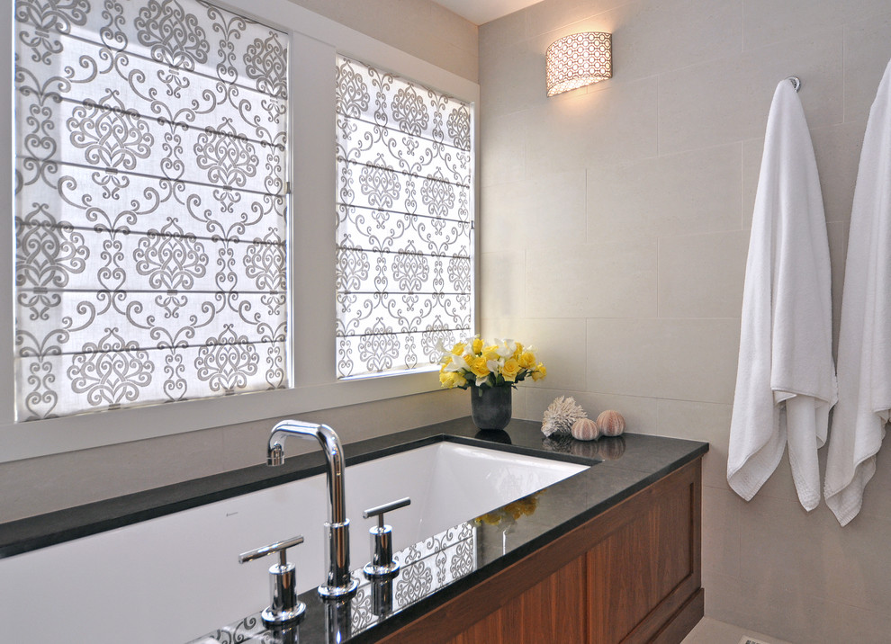 Transitional master beige tile and porcelain tile bathroom photo in Calgary with an undermount tub and beige walls