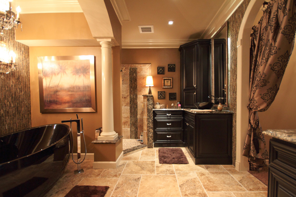 Example of a large trendy master beige tile and ceramic tile travertine floor and beige floor bathroom design in St Louis with raised-panel cabinets, black cabinets, a two-piece toilet, brown walls, a vessel sink and granite countertops