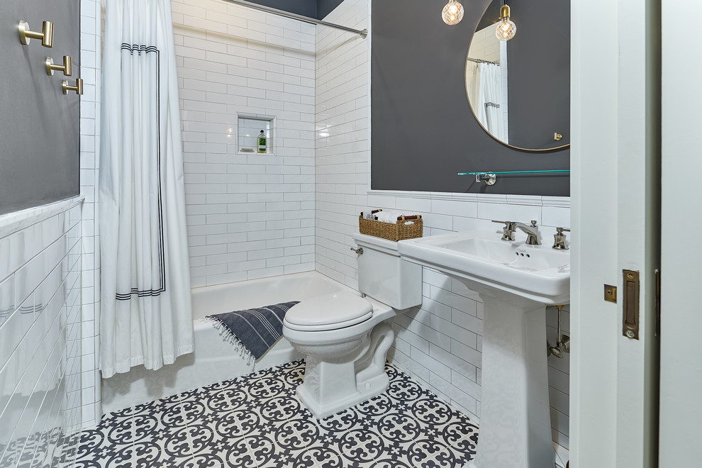 Example of a mid-sized beach style master gray tile and ceramic tile mosaic tile floor and black floor bathroom design in Charleston with white cabinets, a wall-mount toilet, gray walls, a drop-in sink and white countertops