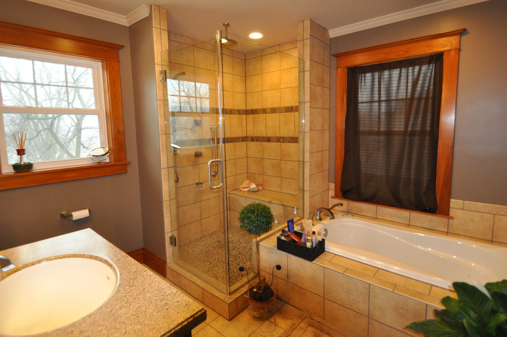 シカゴにある高級なエクレクティックスタイルのおしゃれな浴室 (一体型シンク、家具調キャビネット、中間色木目調キャビネット、人工大理石カウンター、ドロップイン型浴槽、シャワー付き浴槽	、磁器タイル) の写真