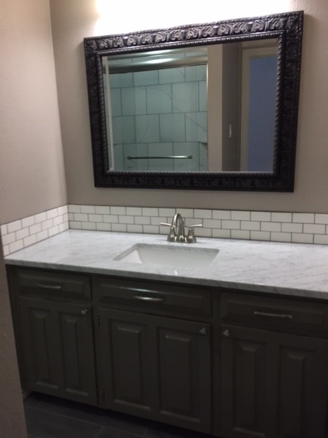 Inspiration for a medium sized classic ensuite bathroom in Dallas with raised-panel cabinets, black cabinets, white tiles, metro tiles, beige walls, a submerged sink and marble worktops.