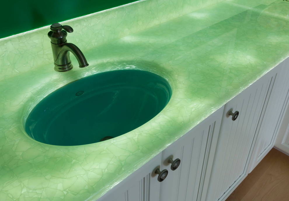 Inredning av ett maritimt stort grön grönt en-suite badrum, med luckor med profilerade fronter, vita skåp, ett fristående badkar, en hörndusch, stenhäll, gröna väggar, ljust trägolv, ett undermonterad handfat och bänkskiva i onyx