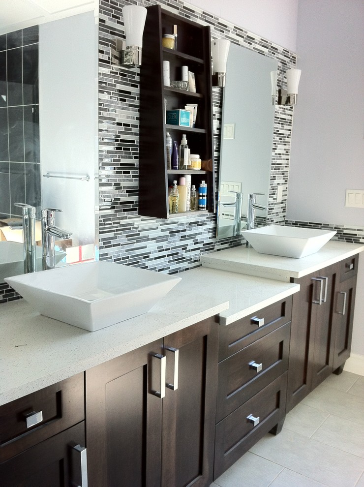 Inspiration for a medium sized modern ensuite bathroom in Vancouver with a vessel sink, shaker cabinets, dark wood cabinets, granite worktops, multi-coloured tiles and mosaic tiles.