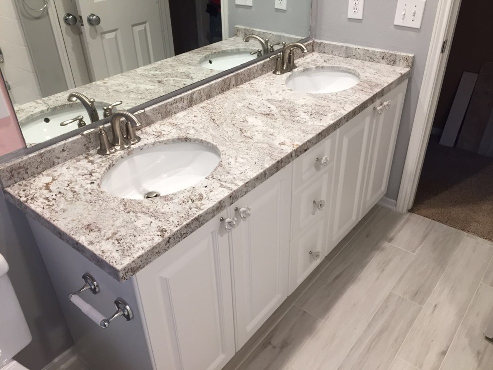 This is an example of a medium sized traditional bathroom in Houston with beaded cabinets and white cabinets.