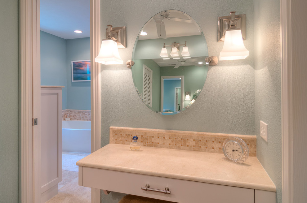 Example of a classic bathroom design in Dallas with recessed-panel cabinets and blue walls