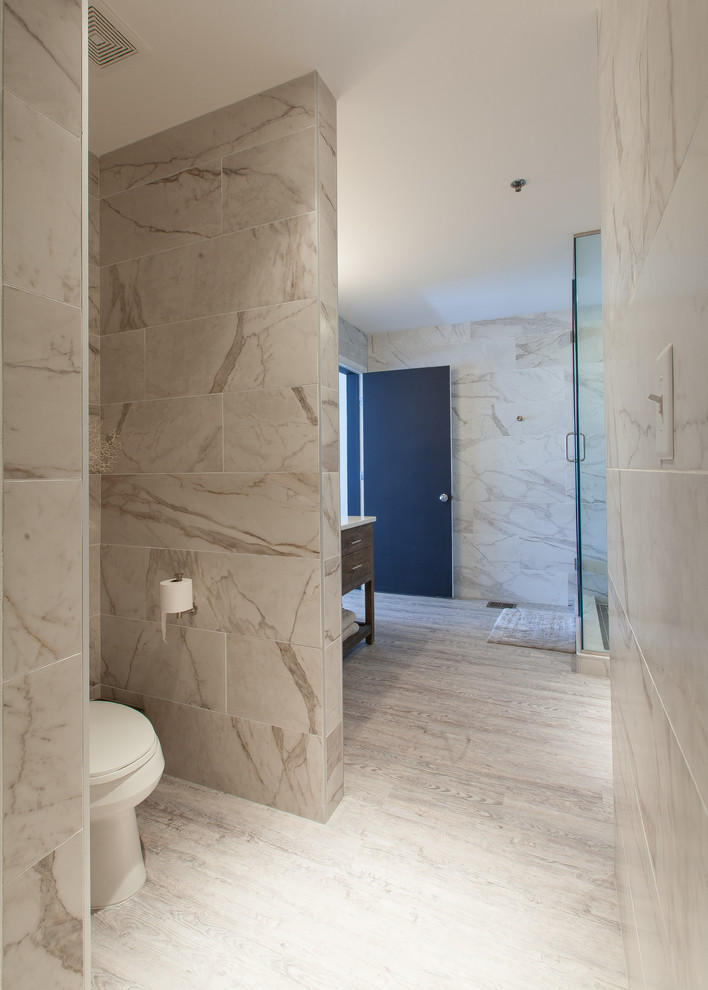 Example of a mid-sized master beige tile and ceramic tile corner shower design in Atlanta with beaded inset cabinets, a one-piece toilet, a drop-in sink and quartz countertops