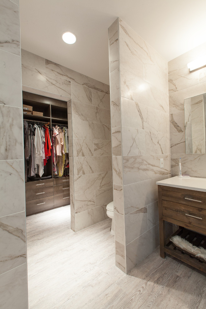 This is an example of a medium sized ensuite bathroom in Atlanta with beaded cabinets, a corner shower, a one-piece toilet, beige tiles, ceramic tiles, a built-in sink and engineered stone worktops.
