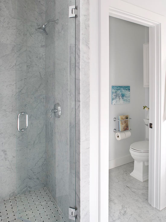 Inspiration for a timeless white tile and stone tile doorless shower remodel in Los Angeles with an undermount sink, marble countertops, an undermount tub, a two-piece toilet and white cabinets