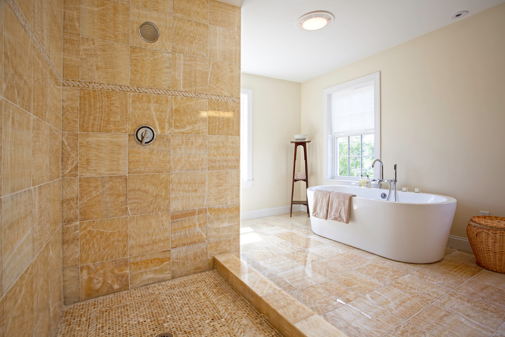 Photo of a large contemporary ensuite bathroom in Boston with a freestanding bath, flat-panel cabinets, brown cabinets, a corner shower, a one-piece toilet, beige tiles, multi-coloured tiles, beige walls, porcelain flooring and a trough sink.