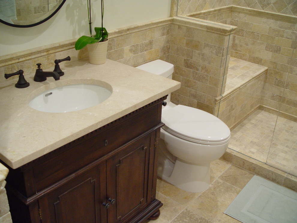 This is an example of a medium sized classic bathroom in Santa Barbara with a submerged sink, distressed cabinets, a walk-in shower, a one-piece toilet, beige walls and limestone flooring.