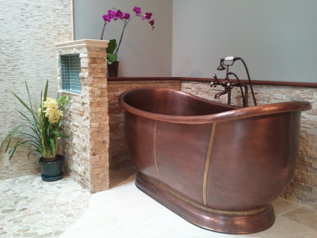 Cette photo montre une salle de bain principale et longue et étroite chic de taille moyenne avec une baignoire indépendante, un espace douche bain, un carrelage beige, un carrelage de pierre, un mur beige, un sol en travertin, un sol beige et meuble-lavabo encastré.