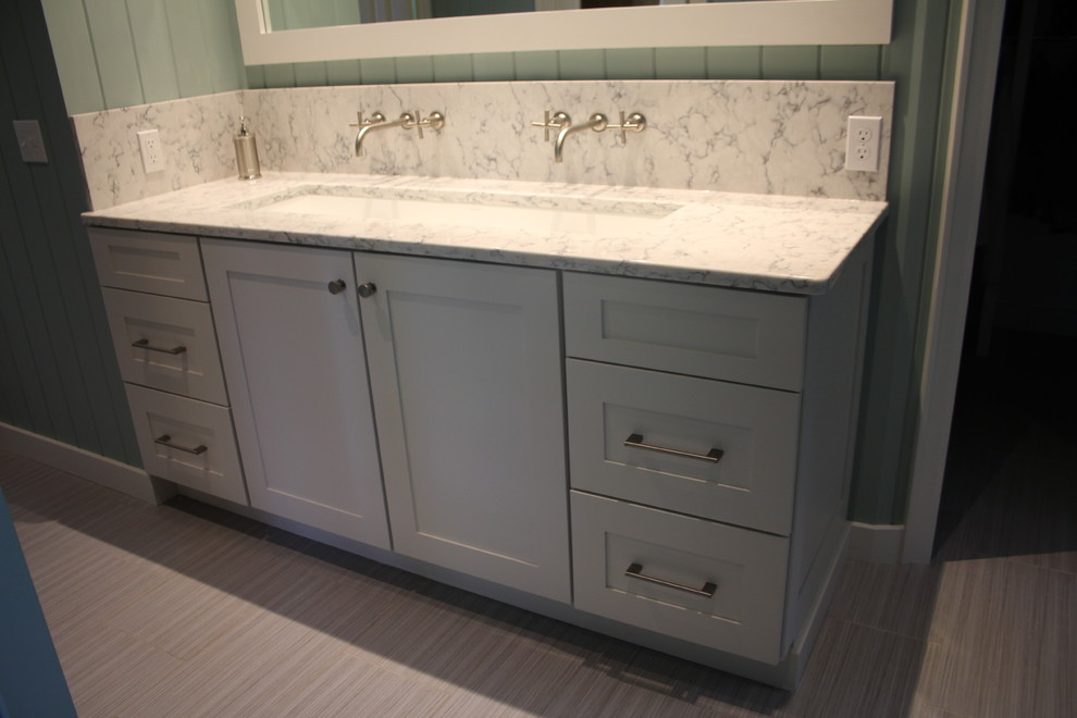 Example of a mid-sized beach style master bathroom design in Grand Rapids with recessed-panel cabinets, beige cabinets, quartz countertops and a trough sink