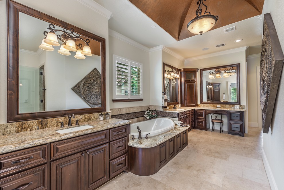 Inspiration for a huge transitional master beige tile, brown tile, gray tile, multicolored tile and mosaic tile travertine floor and beige floor bathroom remodel in Houston with raised-panel cabinets, dark wood cabinets, beige walls, an undermount sink, granite countertops and a hinged shower door