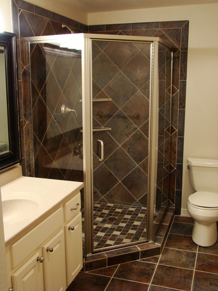 Medium sized traditional shower room bathroom in Denver with raised-panel cabinets, white cabinets, a corner shower, a two-piece toilet, beige tiles, brown tiles, white tiles, porcelain tiles, beige walls, porcelain flooring, an integrated sink and solid surface worktops.