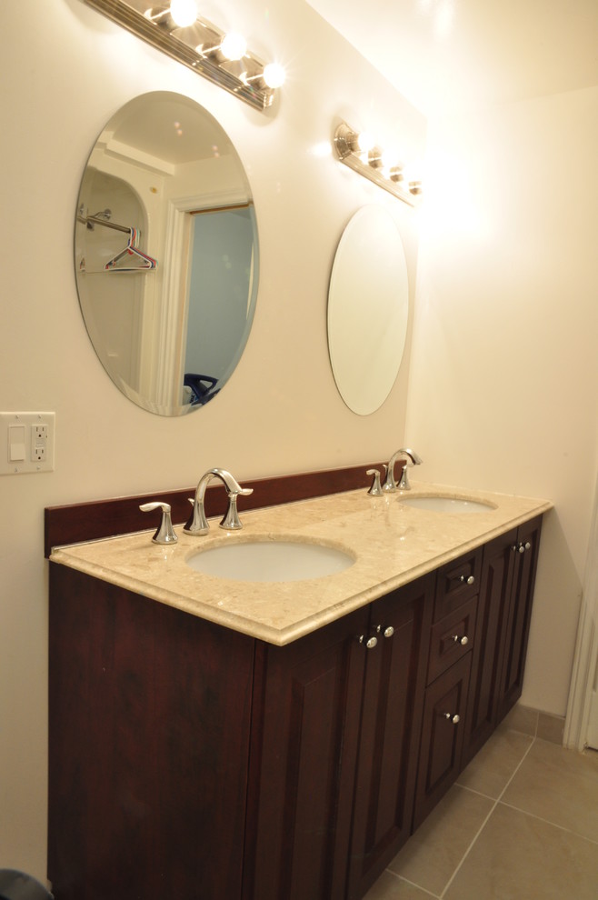 This is an example of a medium sized traditional family bathroom in Ottawa with a submerged sink, dark wood cabinets, solid surface worktops, beige walls and ceramic flooring.