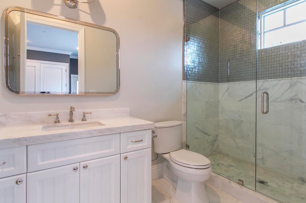 Small traditional shower room bathroom in Los Angeles with white cabinets, white walls, a submerged sink, marble worktops, an alcove shower, a two-piece toilet, stone tiles, marble flooring, beaded cabinets, grey tiles, white tiles, white floors and a hinged door.