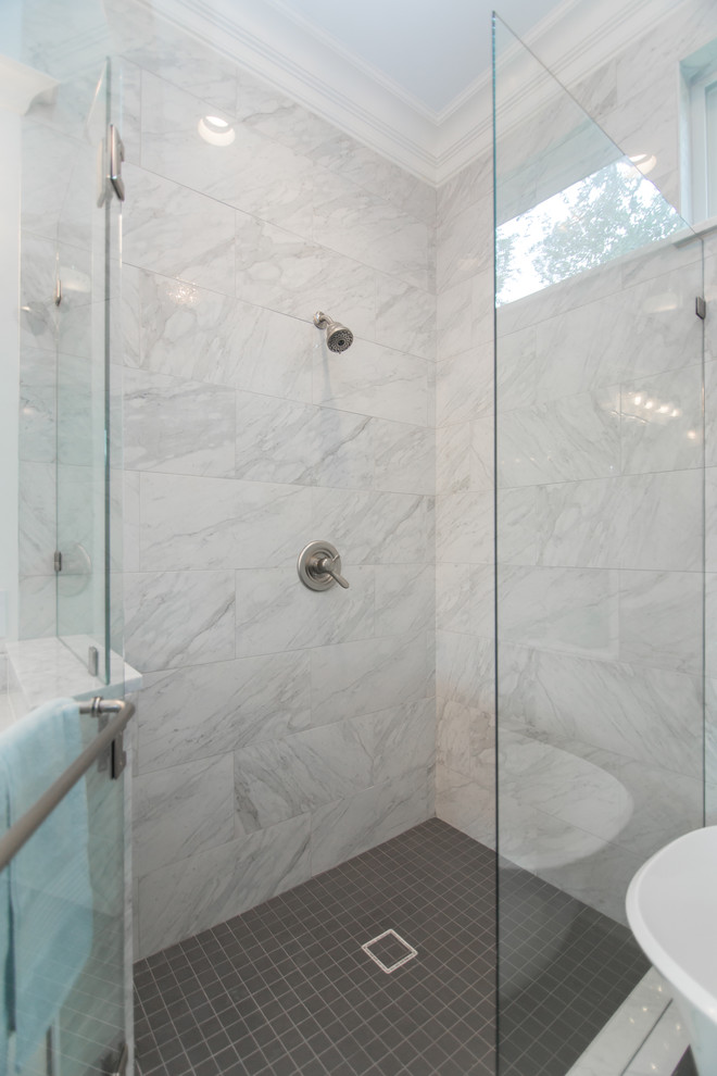 Inspiration for a large classic ensuite bathroom in Dallas with glass-front cabinets, white cabinets, a freestanding bath, a corner shower, a one-piece toilet, white tiles, marble tiles, white walls, porcelain flooring, a submerged sink, marble worktops, grey floors, a hinged door and white worktops.