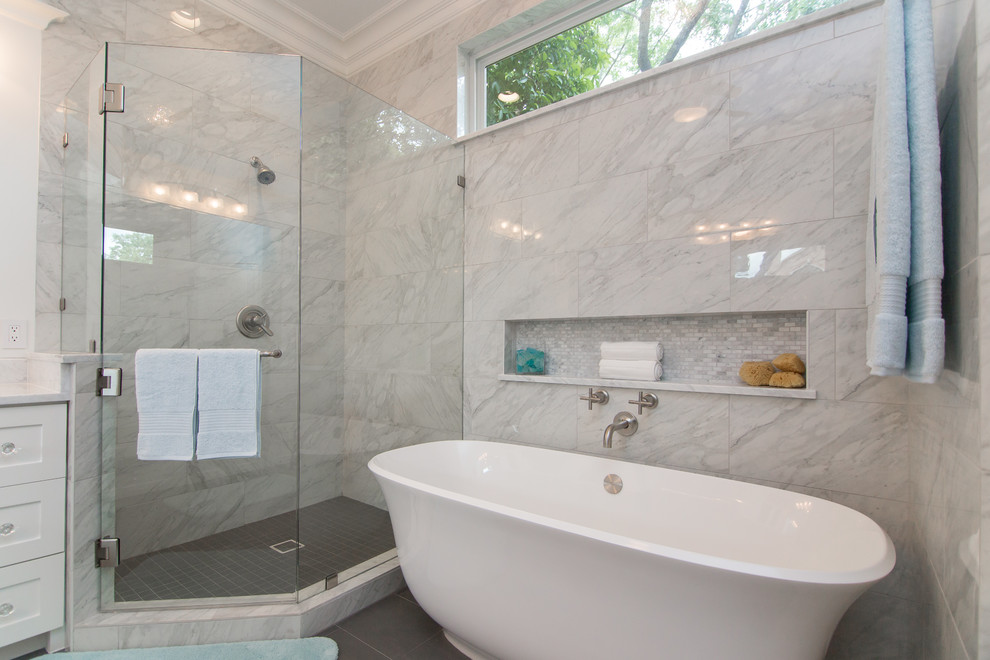 Design ideas for a large traditional ensuite bathroom in Dallas with glass-front cabinets, white cabinets, a freestanding bath, a corner shower, a one-piece toilet, white tiles, marble tiles, white walls, porcelain flooring, a submerged sink, marble worktops, grey floors, a hinged door and white worktops.