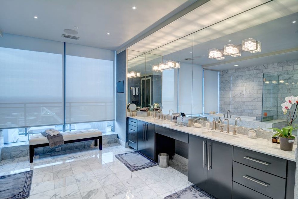 Inspiration for a large classic ensuite bathroom in Atlanta with flat-panel cabinets, black cabinets, a built-in bath, a corner shower, a two-piece toilet, white tiles, marble tiles, grey walls, marble flooring, a submerged sink, marble worktops, white floors, a hinged door and white worktops.
