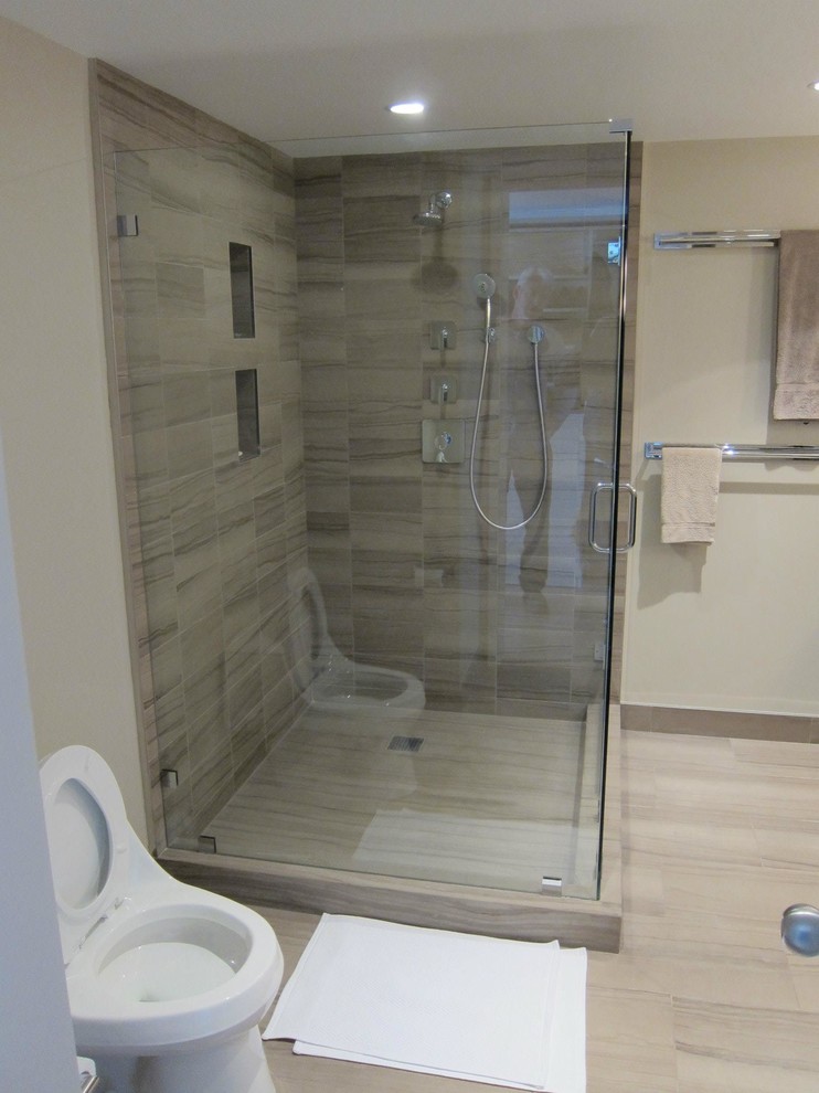 This is an example of a large modern ensuite bathroom in San Francisco with flat-panel cabinets, dark wood cabinets, a corner shower, a one-piece toilet, white walls, a submerged sink, marble flooring, blue tiles, stone tiles and granite worktops.