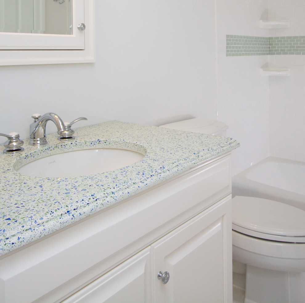 Example of a mid-sized beach style green tile, white tile and subway tile ceramic tile bathroom design in Other with raised-panel cabinets, white cabinets, a two-piece toilet, white walls, an undermount sink and quartz countertops