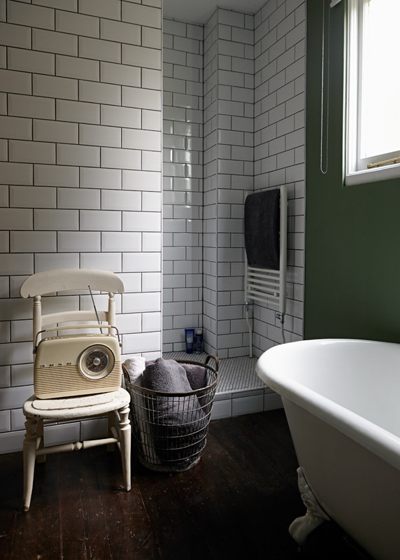 Photo of a traditional bathroom in London with a freestanding bath, a walk-in shower, green walls, dark hardwood flooring and an open shower.