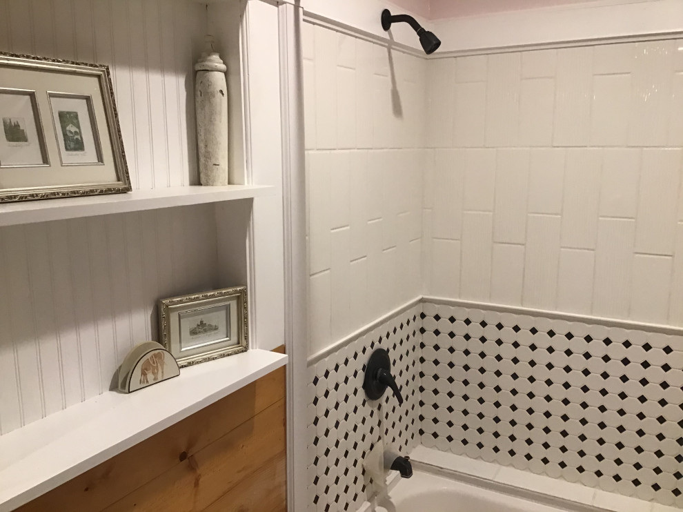 This is an example of a small ensuite bathroom in St Louis with freestanding cabinets, black cabinets, a built-in bath, a walk-in shower, ceramic flooring, a submerged sink, multi-coloured floors, a shower curtain, an enclosed toilet, a single sink, a freestanding vanity unit and wood walls.