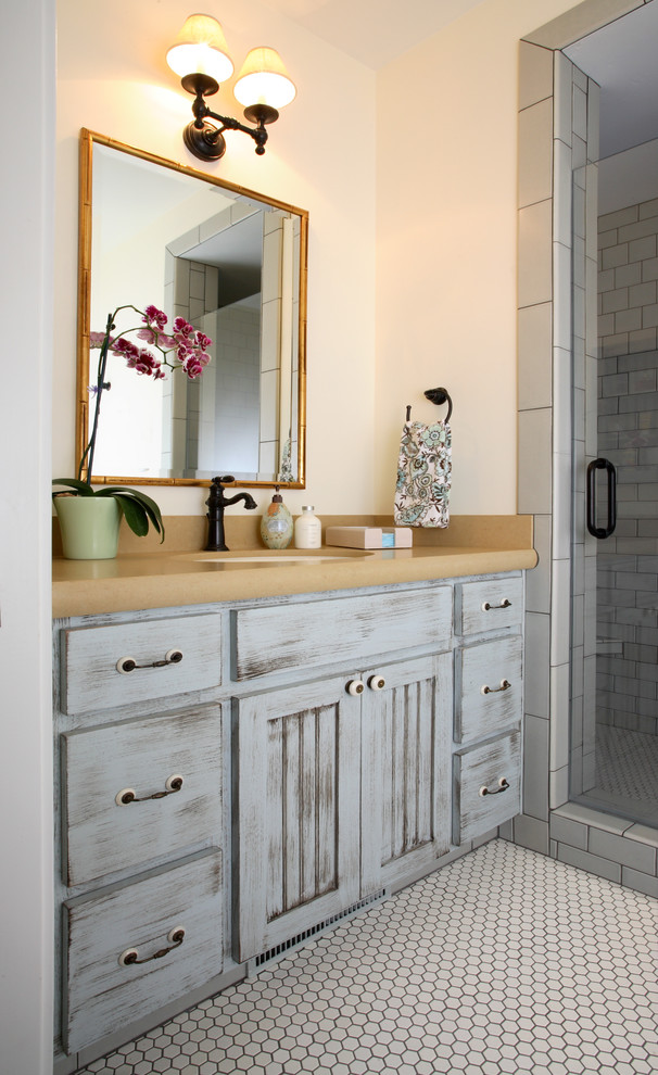 Aménagement d'une salle de bain classique en bois vieilli de taille moyenne avec un lavabo encastré, un placard à porte affleurante, une douche d'angle, un carrelage bleu et un mur bleu.