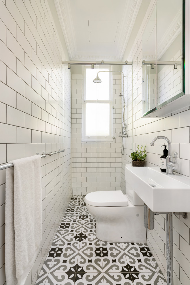 Inspiration for a transitional white tile and subway tile multicolored floor and single-sink bathroom remodel in Sydney with a console sink
