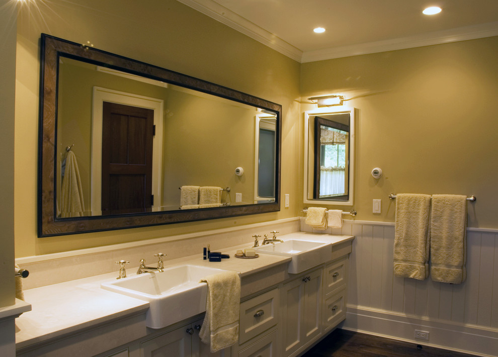 Example of a classic white tile and ceramic tile medium tone wood floor bathroom design in Other with a console sink, recessed-panel cabinets, white cabinets, quartz countertops and yellow walls